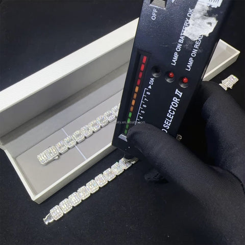 Diamond bracelet being tested with a diamond tester on a black surface


