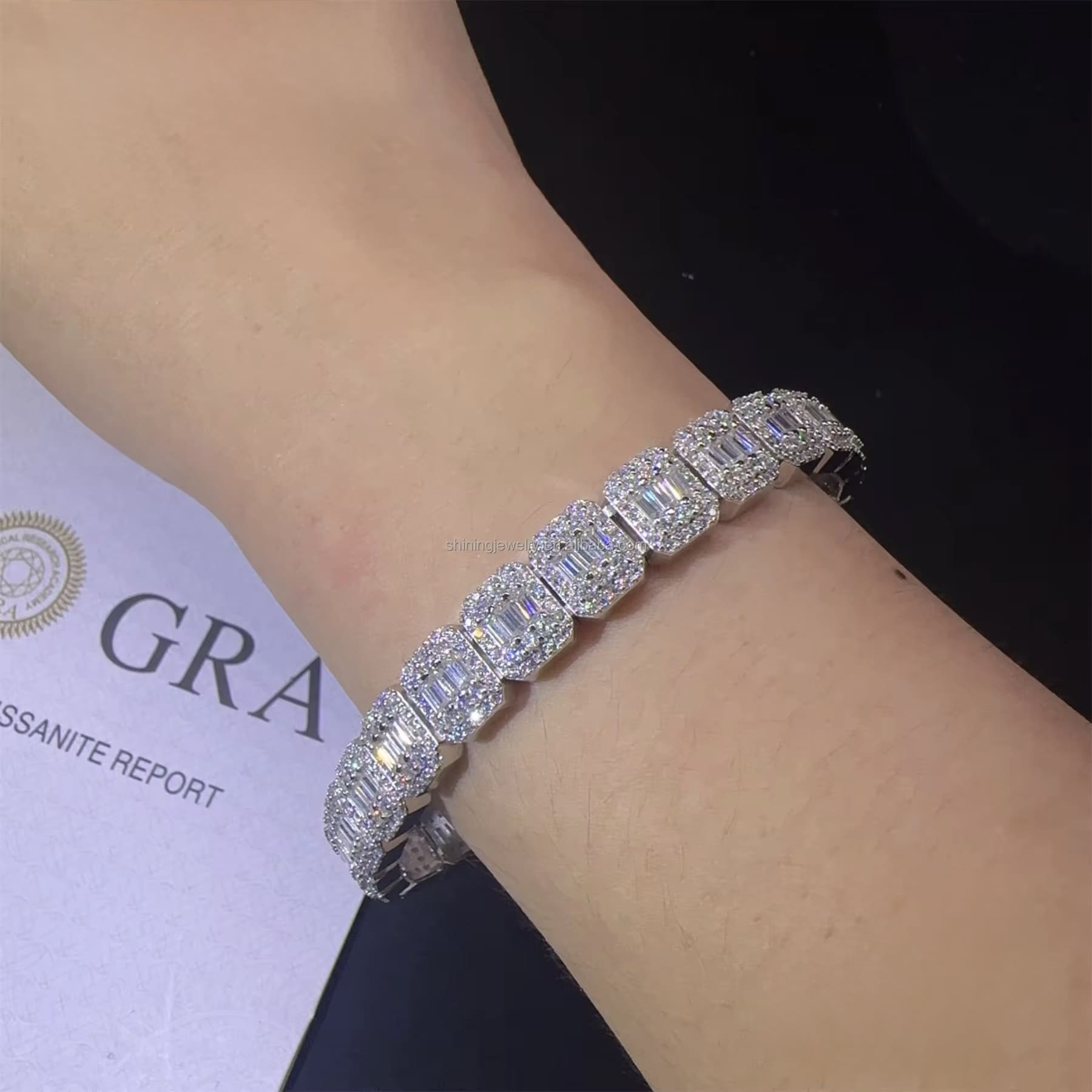 Diamond bracelet on a wrist with a Gravisite report in the background