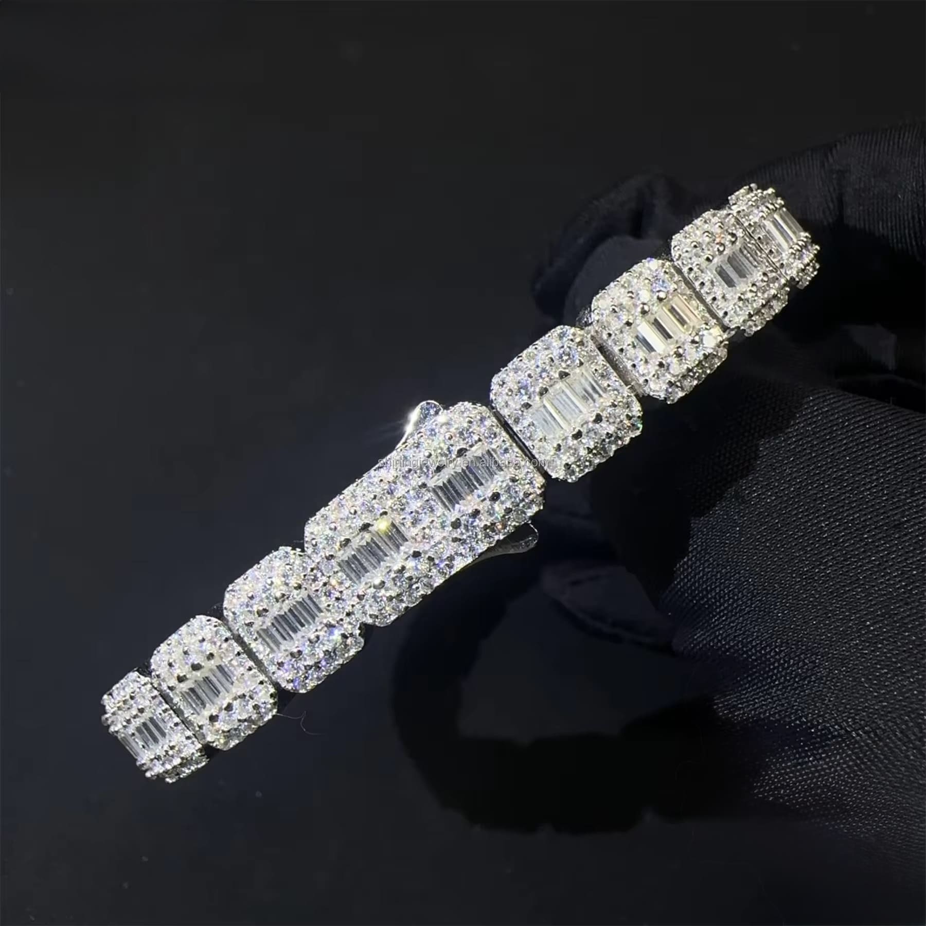 Silver bracelet with clear gemstones on a black background

